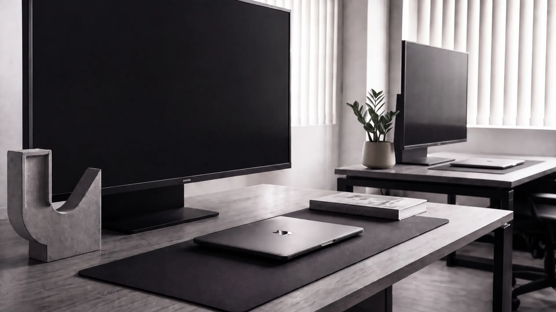 A pared-back Designco workstation with a cast-concrete bookend