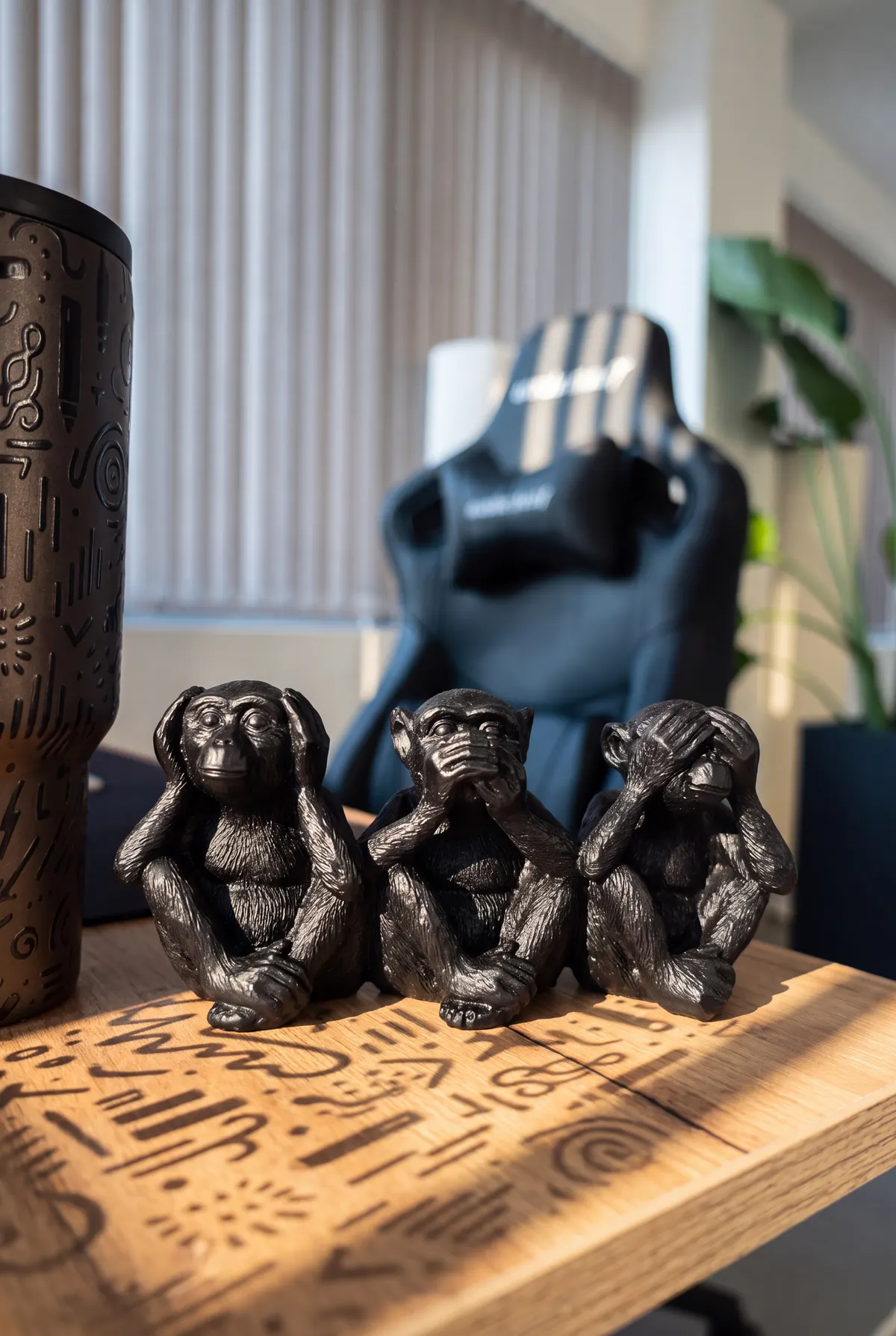 Three wise monkeys keeping watch over a Designco desk